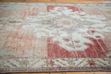 Decorative distressed texture of Oushak carpet, sun-kissed cinnabar red with silvery grey.