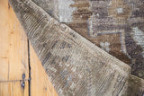 Woven foundation and folded edge of a vintage Oushak carpet, showing abrash pile.
