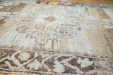 Bronze, charcoal, and beige abrash stretches showcasing expressive Oushak rug motifs.