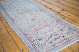 Distressed Turkish Oushak runner showcasing soft pastel lattice pattern on a cool ivory field.