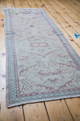 Distressed vintage 1960s Oushak runner showing pastel lattice design and worn pile.