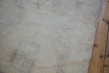 Blanched pile texture showing subtle faded multi-medallion patterns on this distressed Oushak runner.