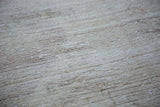 Distressed Oushak rug pile, blanched with subtle, textural striations.