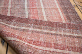 Flat woven texture of Kilim rug runner in rose red and wine burgundy striations.