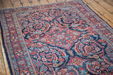 Vintage Mahal rug with indigo field, pinwheel designs, and brick red, aqua teal meandering border.