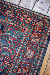 Brilliant brick red meandering leaf border and indigo navy field of a Mahal rug.