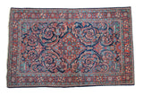 Vintage Mahal rug with indigo field, brick red medallion, and scrolling leaf designs.