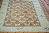 Vintage Oushak rug with brilliant bronze floral field and blanched grey-blue geometric border.