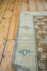 Blanched silvery beige border with grey-blue geometric motifs on the brilliant bronze Oushak rug.