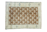 Vintage Oushak rug with brilliant bronze field and blanched grey-blue and cream florals.