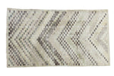 Distressed Oushak rug with checker motif, soft texture, ivory, charcoal, and faded rose.