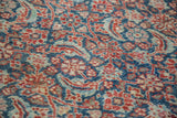 Close-up of Antique Persian Tabriz rug's intricate Herati motif in indigo blue, rusty red.
