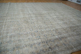Textured distressed Oushak carpet pile with subtle repeating beige and grey medallions.