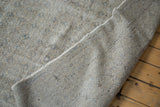 Hand-knotted backing and distressed beige-grey pile of this vintage Oushak carpet.