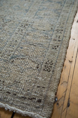 Distressed Oushak rug pile texture, revealing subtle patterns in soft beige, grey, and blue.