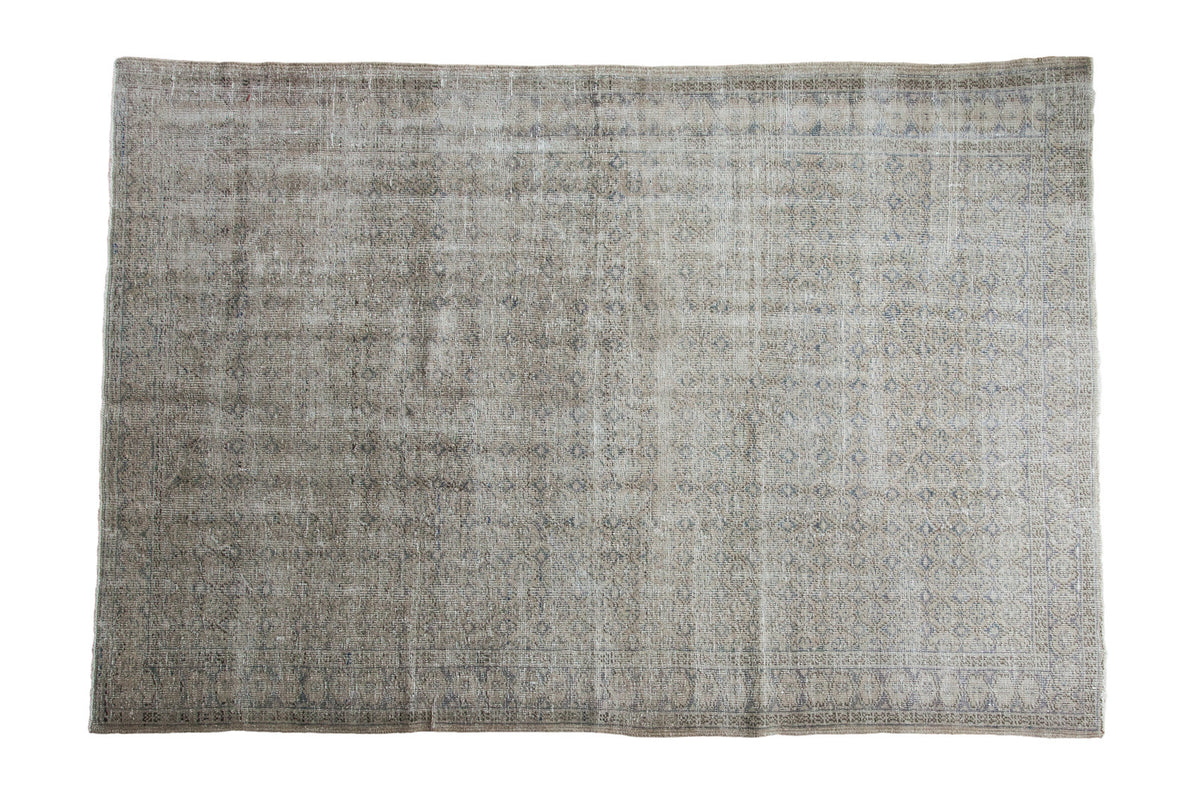 Distressed Oushak Carpet with subtle repeating medallions in muted beige and greyish tones, 6'5" x 9'7".