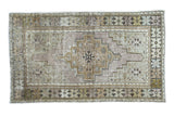 Distressed Vintage Oushak runner with medallion in softened bronze, celadon, light blue, mauve.