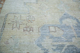 Distressed Oushak runner pile showing blanched beige, silvery gray floral motifs.