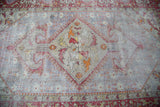 Distressed Oushak carpet, large medallion with brick red sickle leaves on soft grey field, 6'8