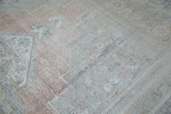 Soft blanched pile with subtle cinnabar coral, platinum, and ivory ornate patterns.