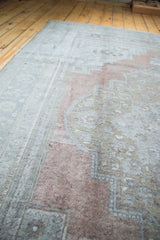 Blended cinnabar coral, platinum, and ivory colors on the vintage Oushak carpet pile.