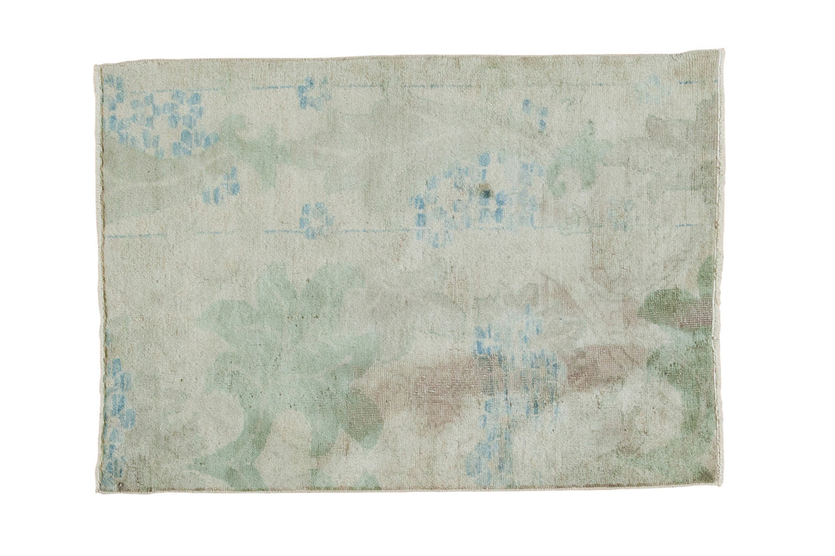 Distressed vintage Oushak rug with faded pastel blue and green arts and crafts plant motifs.