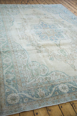 Distressed Oushak rug corner, blanched aqua European meandering leaf palmette border.