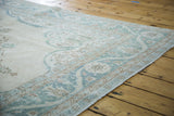 Distressed Oushak rug corner, blanched aqua European border with meandering leaf and palmette motifs.