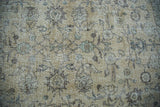 Close-up of distressed Oushak carpet, faded ivory, earth tones, allover floral design.