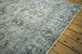 Distressed Turkish Oushak carpet with softened ivory and earth tone allover pattern.