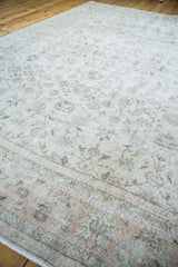 Distressed Oushak carpet showing softened ivory pile and muted floral patterns.