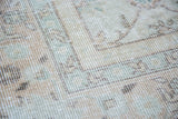 Super softened faded ivory, beige, and light green shades on a distressed Oushak pile.