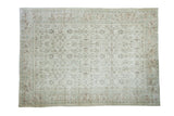 Distressed Oushak carpet featuring faded floral designs, softened ivory and earth tones, 7'1