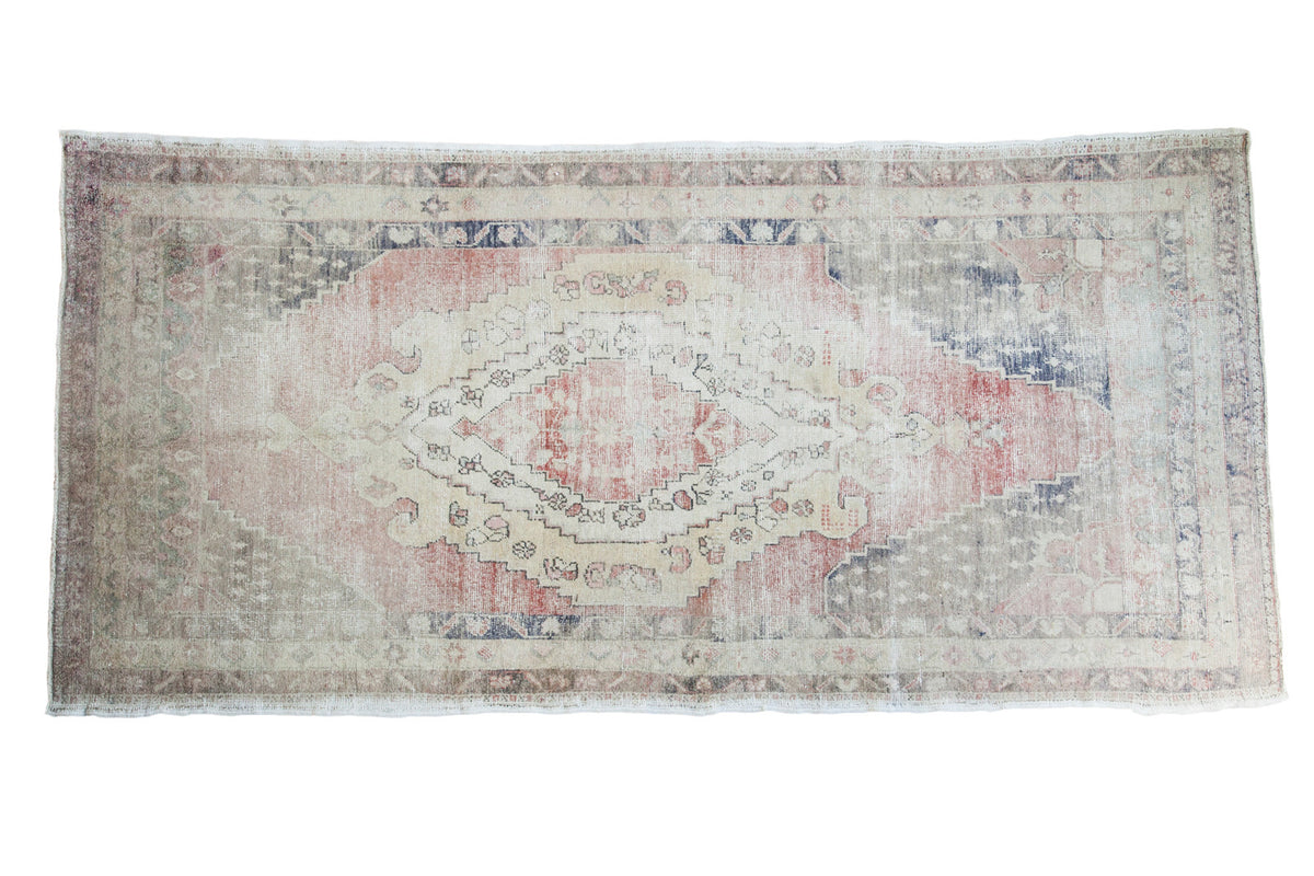 Distressed vintage Oushak rug runner with red, cream, navy lozenge medallions, 5' x 10'4".