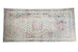 Distressed vintage Oushak rug runner with red, cream, navy lozenge medallions, 5' x 10'4