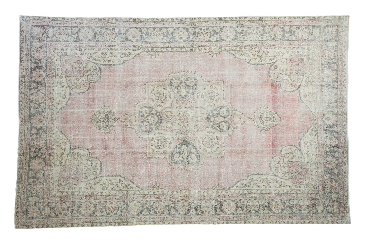 Distressed Oushak carpet, rosy mauve field, neutral medallion, blanched texture, 6'7" x 10'4".