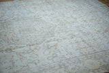 Blanched ivory field and faded patterns of a distressed vintage Oushak carpet.