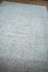 Blanched field of the distressed Oushak rug with light ivory and subtle beige motifs.