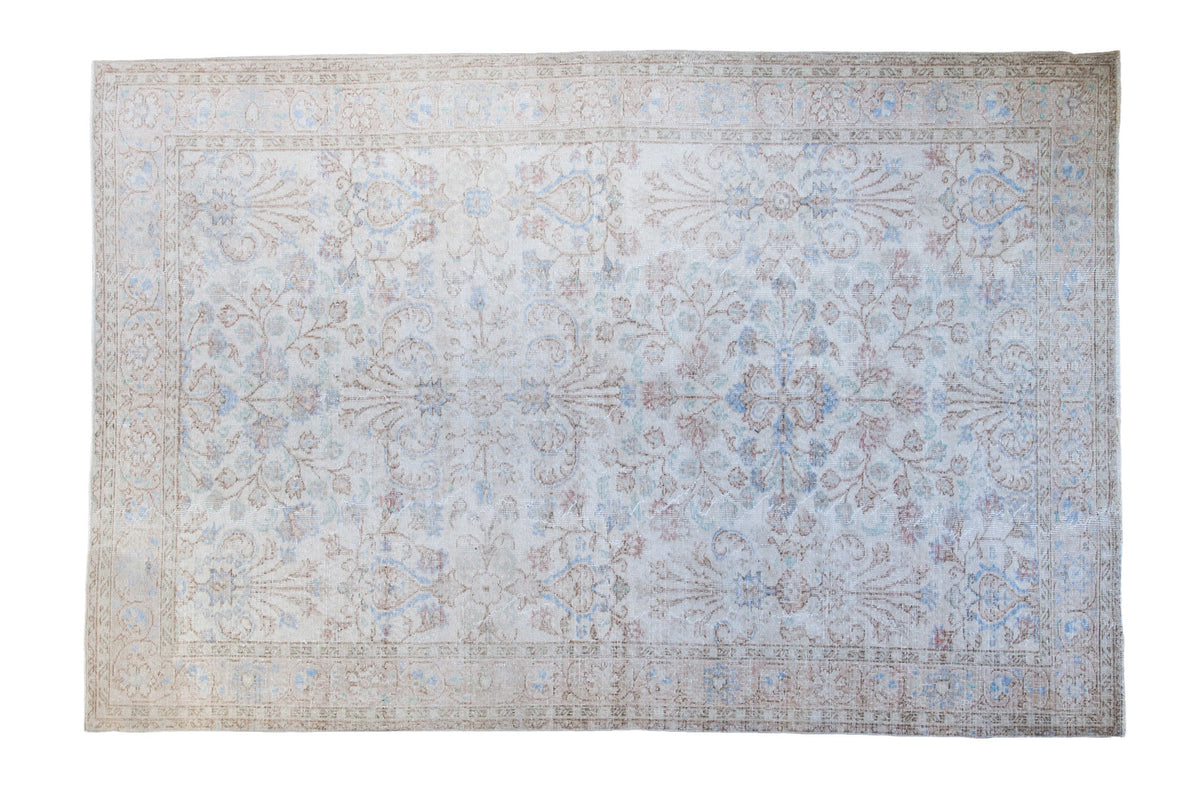 Distressed Oushak carpet, floral pattern, blanched ivory, coral, light blue. 6'2" x 9'3".