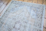 Distressed vintage Oushak runner, geometric styling in light beige, ivory, and charcoal tones.