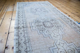 Distressed Oushak runner showcasing faded geometric medallions in goldeny beige and silver charcoal.