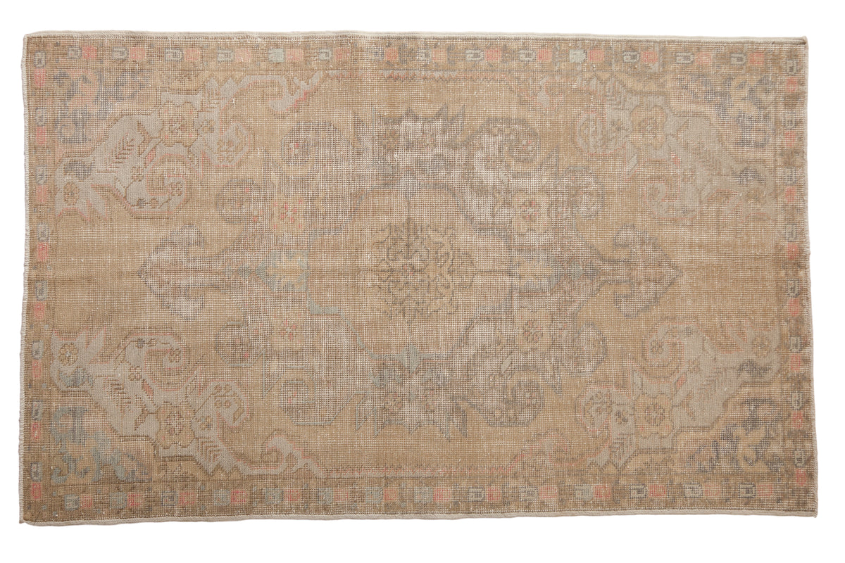 Distressed vintage Oushak rug with a gold field and blanched silver, rose, ivory tones, 4x7.