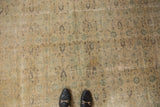 Distressed vintage Oushak carpet, blanched ivory, green, beige tones, allover repeating design.