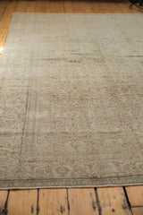 Distressed Oushak rug's intricate weave and blanched ivory, green, beige tones.
