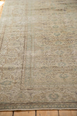 Intricate blanched ivory, beige, and green curvilinear design on the distressed vintage Oushak rug.