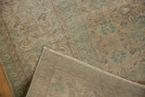Distressed Oushak rug pile in faded beige and green reveals its tight, intricate vintage weave.