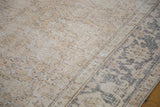 Faded neutral colors and distressed texture of vintage Oushak carpet with intricate Lotto motif.