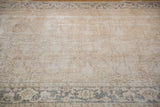 Distressed Turkish Oushak rug, showing faded beige shadow Lotto motif and patterned gray border.