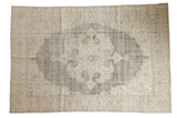 Distressed Oushak carpet features a blanched ivory medallion on a charcoal field, 6'10