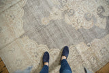 Distressed Oushak carpet with intricate blanched ivory and beige design on a softened charcoal ground.